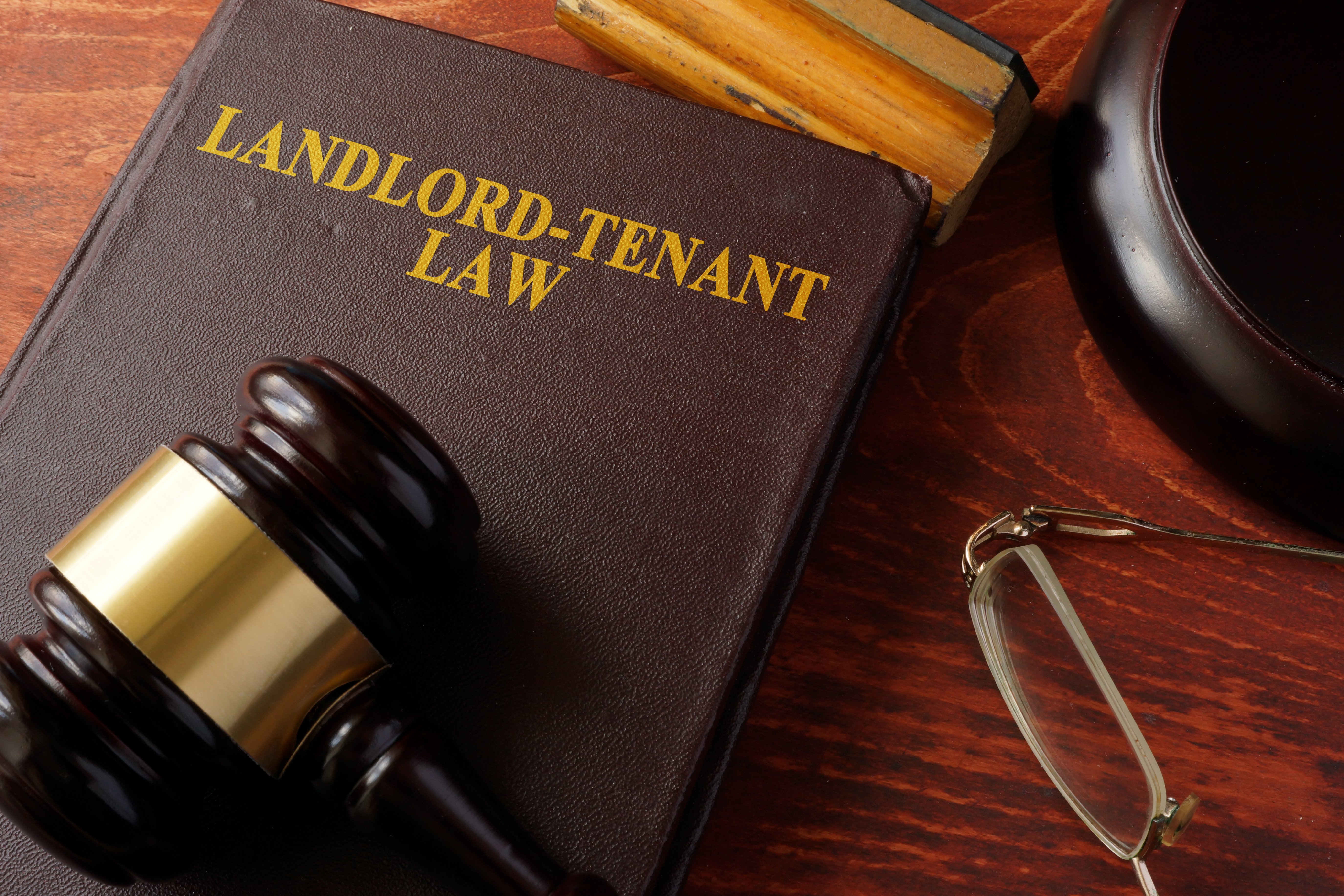 landlord tenant law book on desk with gavel